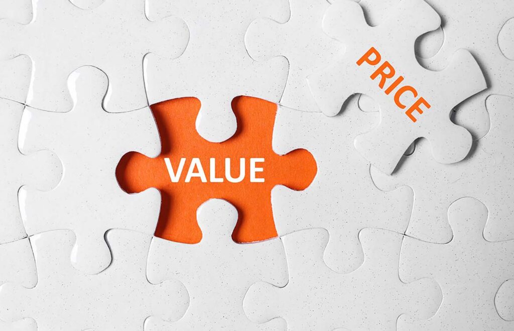 Puzzle with phrase PRICE VALUE on orange background, top view